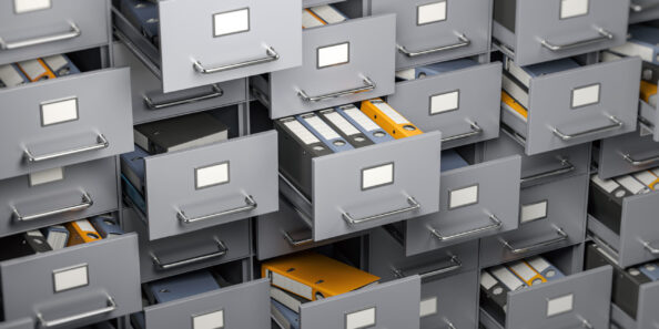 File cabinet full of foders. Storage, organization and administration concept.